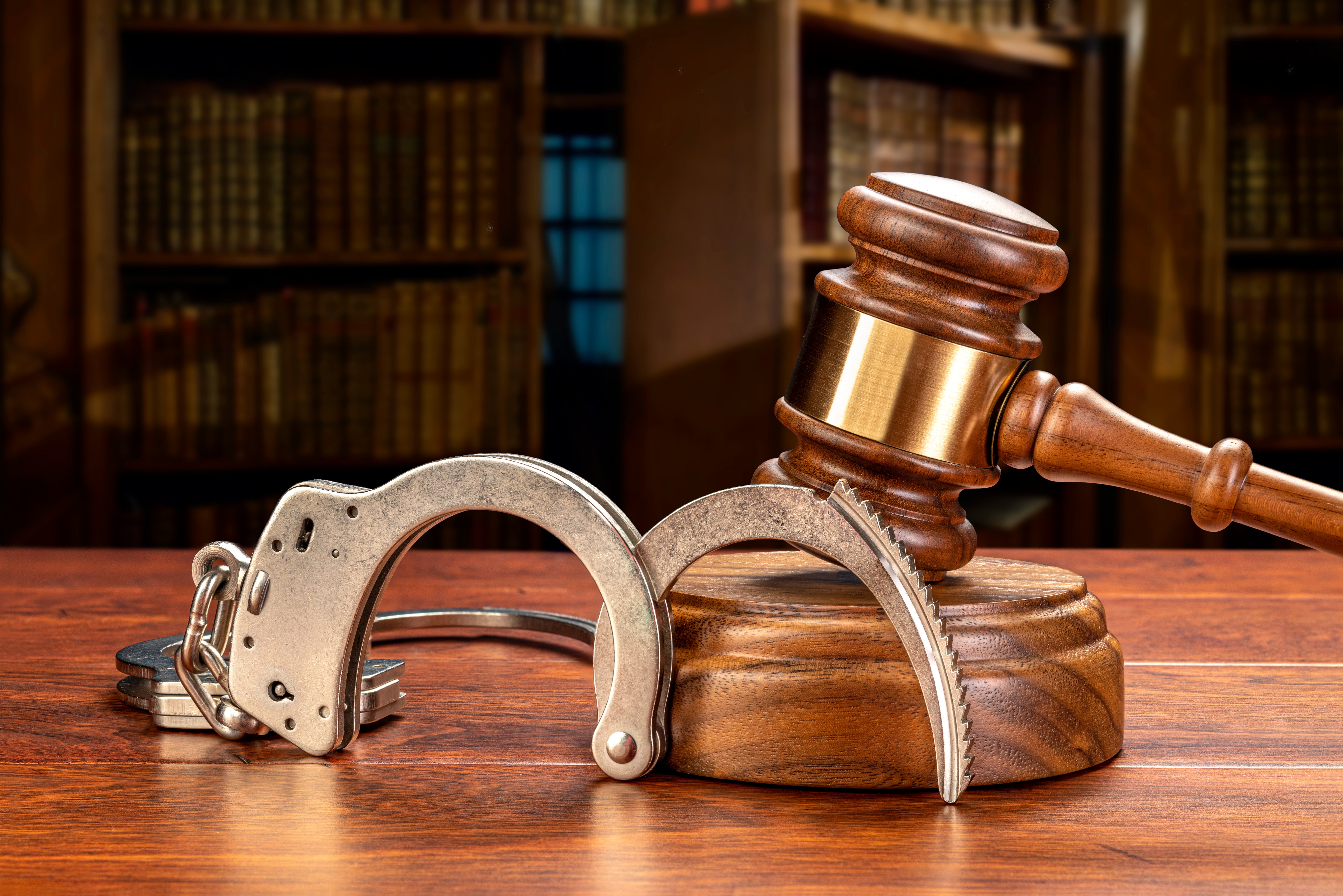 handcuffs-and-gavel-in-law-library-2021-10-06-17-41-00-utc